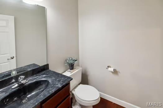 754 Michael St, Ofallon, IL 62269 - bathroom with vanity, toilet, baseboards, and wood finished floors