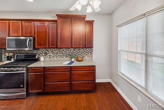 754 Michael St, Ofallon, IL 62269 - kitchen featuring appliances with stainless steel finishes, dark wood finished floors, tasteful backsplash, baseboards, and ceiling fan