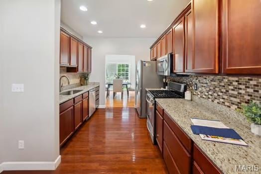 754 Michael St, Ofallon, IL 62269 - kitchen featuring stainless steel appliances, a sink, backsplash, dark wood-style flooring, and baseboards