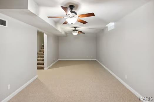 754 Michael St, Ofallon, IL 62269 - spare room with light carpet, stairs, ceiling fan, and baseboards