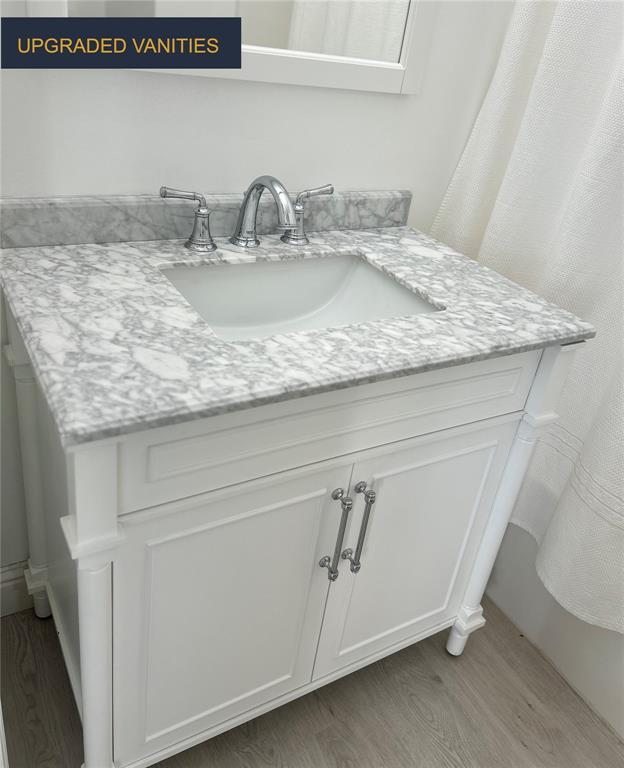 1021 Kilderkin Way, Saint Charles, MO 63301 - bathroom with wood finished floors and vanity