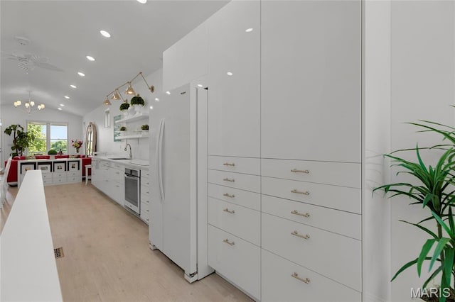 1021 Kilderkin Way, Saint Charles, MO 63301 - kitchen featuring freestanding refrigerator, white cabinetry, light wood-style flooring, lofted ceiling, and recessed lighting