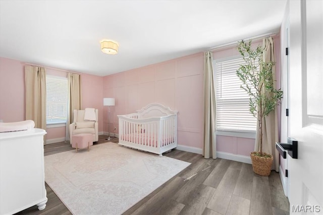 2774 Ashrock Dr, Saint Louis, MO 63129 - bedroom featuring wood finished floors, baseboards, and a crib