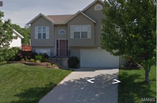 220 Split Rail Dr, Wentzville, MO 63385 - bi-level home with driveway, a garage, and a front yard