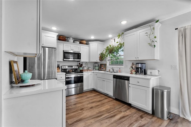 170 Parklane Dr, Cape Girardeau, MO 63701 - kitchen featuring appliances with stainless steel finishes, recessed lighting, white cabinets, light wood-style floors, and light countertops