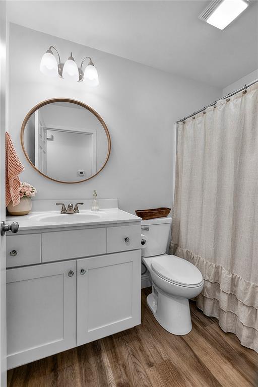 170 Parklane Dr, Cape Girardeau, MO 63701 - bathroom featuring toilet, vanity, and wood finished floors