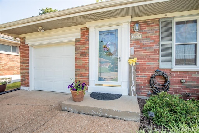 4319 Sinnwell Dr, Saint Louis, MO 63123 - property entrance featuring concrete driveway, brick siding, and a garage