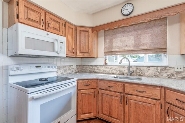 4319 Sinnwell Dr, Saint Louis, MO 63123 - kitchen with white appliances, backsplash, and brown cabinets
