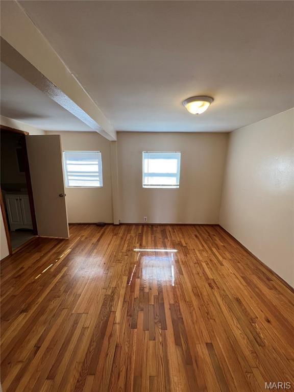 10052 Valley Dr, Riverview, MO 63137 - empty room with wood finished floors and healthy amount of natural light