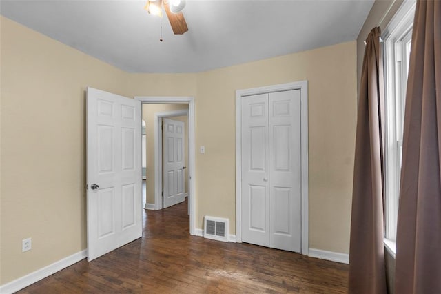 1545 N Main St, Cape Girardeau, MO 63701 - unfurnished bedroom featuring dark wood finished floors, baseboards, a closet, and ceiling fan