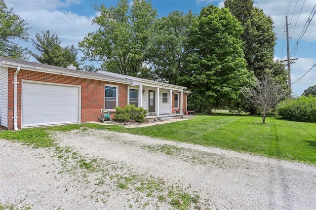 1961 E Union Ave, Litchfield, IL 62056 - ranch-style house featuring a garage, brick siding, a front yard, and dirt driveway