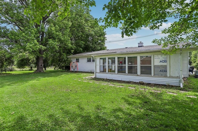 1961 E Union Ave, Litchfield, IL 62056 - back of house featuring a yard and a chimney