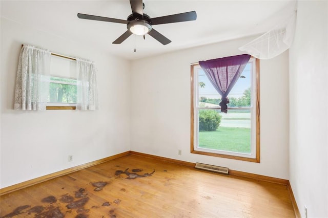 1961 E Union Ave, Litchfield, IL 62056 - empty room with plenty of natural light, wood finished floors, baseboards, and a ceiling fan