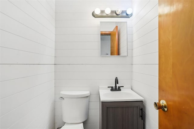 1961 E Union Ave, Litchfield, IL 62056 - half bathroom featuring vanity, toilet, and wooden walls