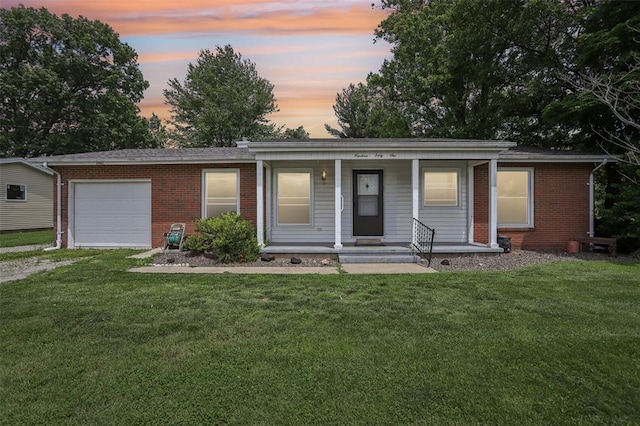 1961 E Union Ave, Litchfield, IL 62056 - ranch-style home with an attached garage, a porch, a front lawn, and brick siding