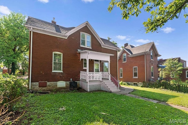 207 Voss Pl, Belleville, IL 62220 - view of front of house with brick siding, a front lawn, a chimney, and a wooden deck