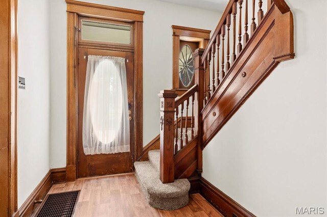 207 Voss Pl, Belleville, IL 62220 - entryway featuring wood finished floors, stairs, and baseboards