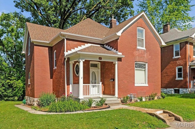 207 Voss Pl, Belleville, IL 62220 - traditional home featuring a chimney, brick siding, a front yard, and roof with shingles