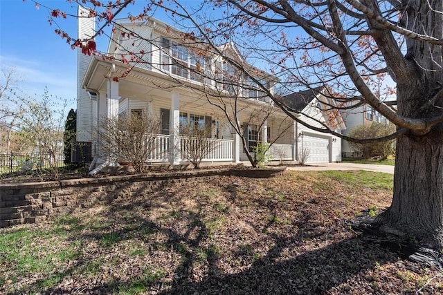 122 Tennessee Walker Way, Saint Peters, MO 63376 - view of front of house featuring a porch, a chimney, a garage, and driveway