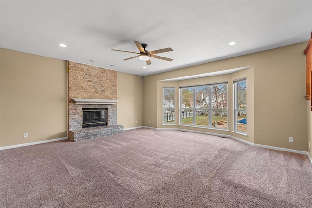 122 Tennessee Walker Way, Saint Peters, MO 63376 - unfurnished living room featuring ceiling fan, carpet, baseboards, a fireplace, and recessed lighting