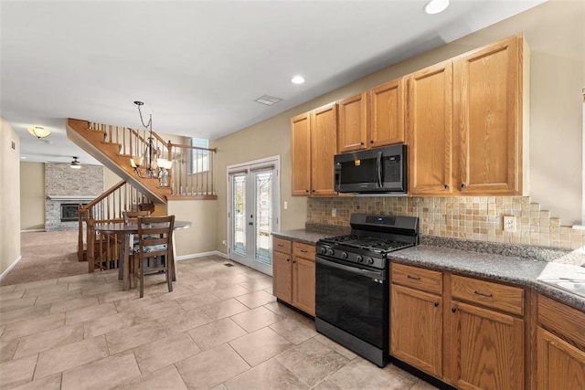 122 Tennessee Walker Way, Saint Peters, MO 63376 - kitchen with black gas range, baseboards, tasteful backsplash, decorative light fixtures, and recessed lighting