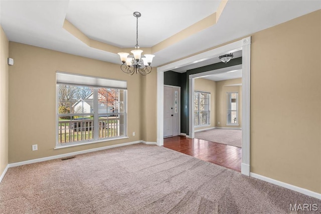 122 Tennessee Walker Way, Saint Peters, MO 63376 - carpeted empty room featuring a chandelier, baseboards, and a raised ceiling