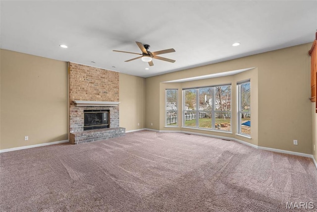 122 Tennessee Walker Way, Saint Peters, MO 63376 - unfurnished living room featuring a ceiling fan, carpet floors, baseboards, a fireplace, and recessed lighting