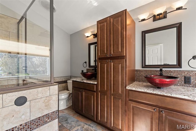 122 Tennessee Walker Way, Saint Peters, MO 63376 - full bathroom featuring vanity, toilet, vaulted ceiling, a wainscoted wall, and tile walls