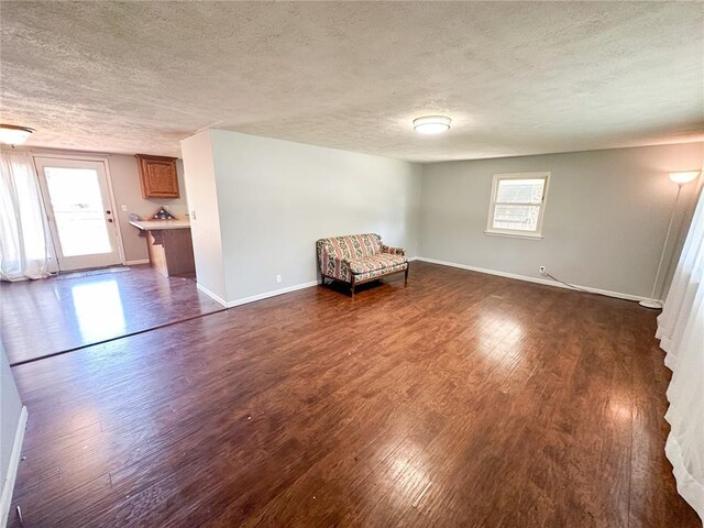 1110 W 3rd St, Salem, MO 65560 - unfurnished room featuring a textured ceiling, dark wood-style flooring, and baseboards