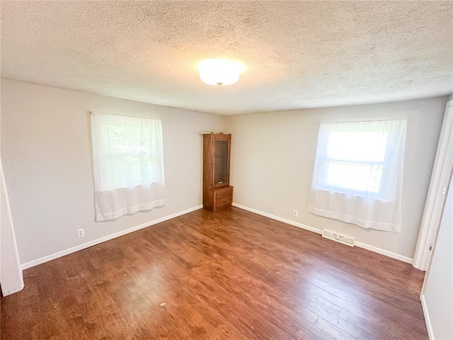 1110 W 3rd St, Salem, MO 65560 - empty room with a textured ceiling, wood finished floors, and baseboards