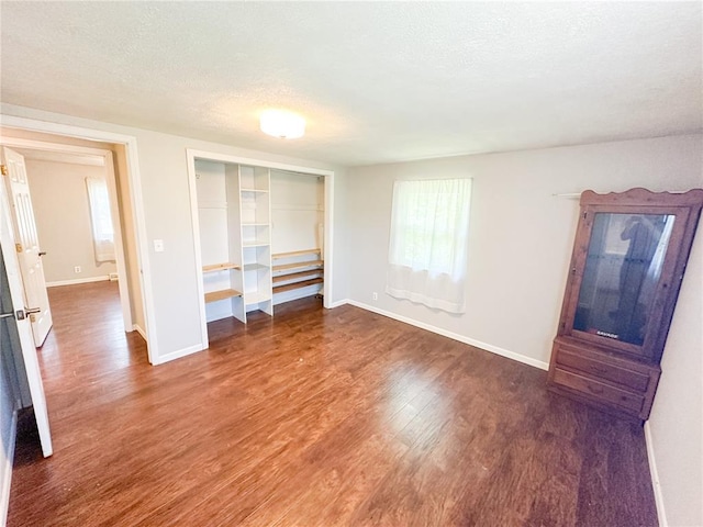 1110 W 3rd St, Salem, MO 65560 - unfurnished bedroom featuring baseboards, a textured ceiling, wood finished floors, and a closet