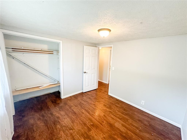 1110 W 3rd St, Salem, MO 65560 - unfurnished bedroom with wood finished floors, baseboards, a closet, and a textured ceiling