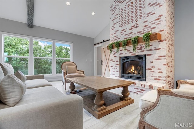 116 Brian Trl, Arnold, MO 63010 - living room featuring high vaulted ceiling, a barn door, a fireplace, and recessed lighting