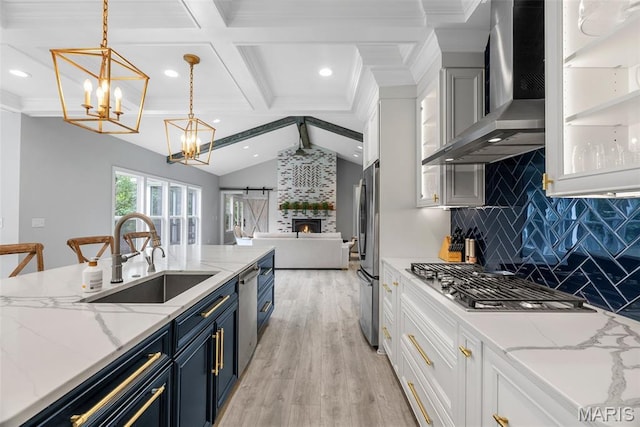 116 Brian Trl, Arnold, MO 63010 - kitchen featuring a sink, blue cabinets, wall chimney range hood, appliances with stainless steel finishes, and tasteful backsplash