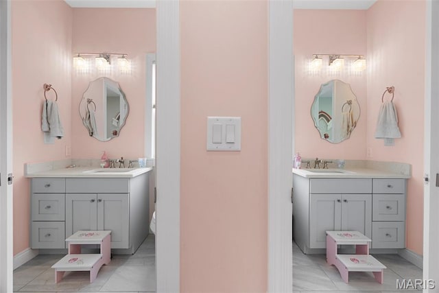 116 Brian Trl, Arnold, MO 63010 - full bathroom with two vanities, baseboards, and tile patterned flooring