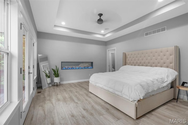 116 Brian Trl, Arnold, MO 63010 - bedroom with light wood-type flooring, a tray ceiling, recessed lighting, baseboards, and ceiling fan