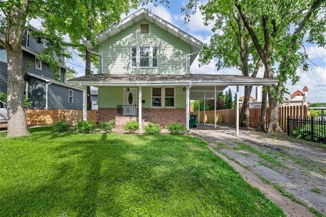 514 S Gore Ave, Saint Louis, MO 63119 - rear view of house featuring asphalt driveway, brick siding, covered porch, and an attached carport