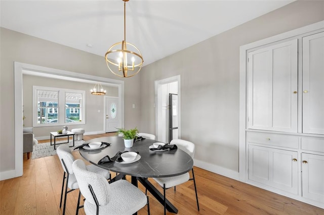 514 S Gore Ave, Saint Louis, MO 63119 - dining space featuring a chandelier, light wood finished floors, and baseboards