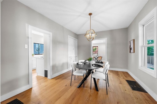 514 S Gore Ave, Saint Louis, MO 63119 - dining area with light wood-type flooring, a chandelier, and baseboards