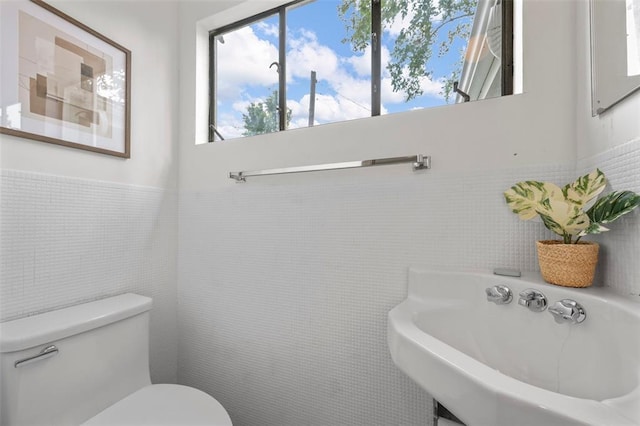514 S Gore Ave, Saint Louis, MO 63119 - half bath featuring tile walls, toilet, and wainscoting