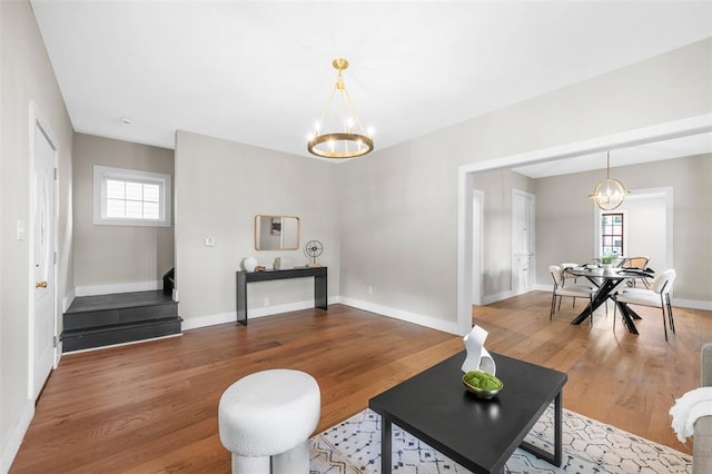 514 S Gore Ave, Saint Louis, MO 63119 - living room featuring a chandelier, wood finished floors, baseboards, and stairs
