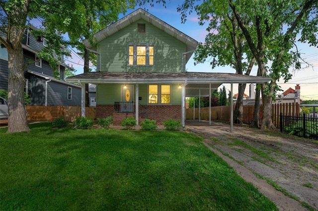 514 S Gore Ave, Saint Louis, MO 63119 - rear view of property featuring brick siding, driveway, a porch, and a carport