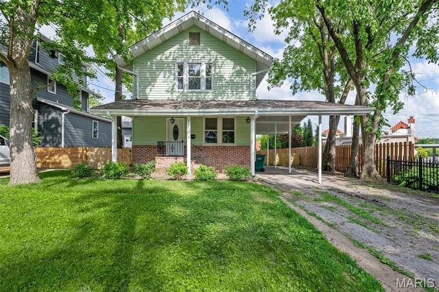 514 S Gore Ave, Saint Louis, MO 63119 - rear view of house with driveway, brick siding, covered porch, and a carport