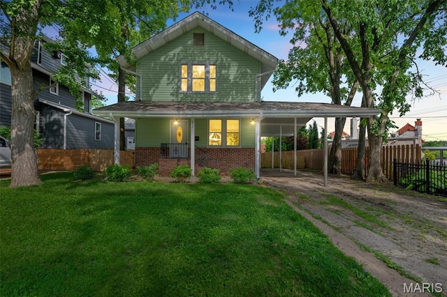 514 S Gore Ave, Saint Louis, MO 63119 - rear view of property with brick siding, driveway, a porch, and an attached carport