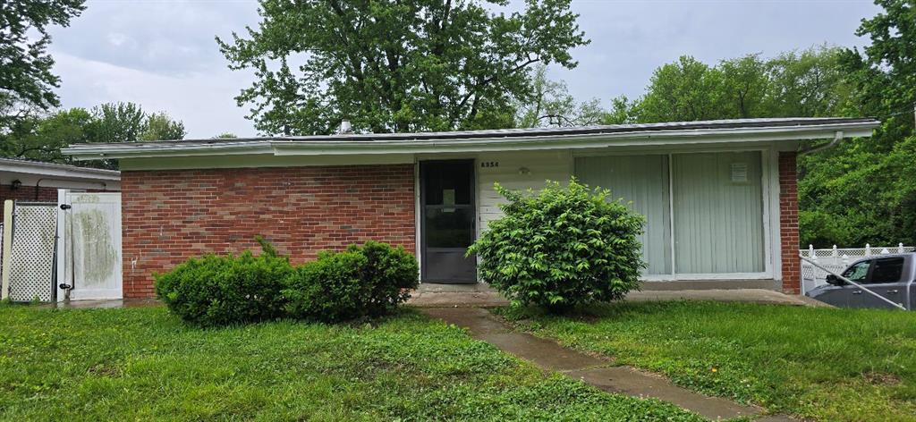 8354 Latty Ave, Hazelwood, MO 63042 - view of front facade featuring brick siding and a front yard