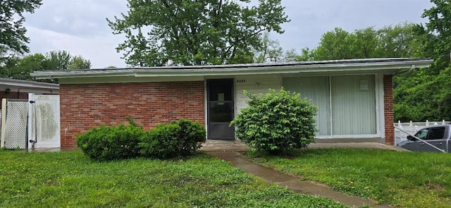 8354 Latty Ave, Hazelwood, MO 63042 - view of front facade featuring brick siding and a front yard