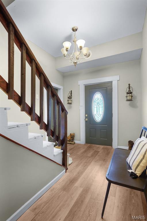 401 S Main St, New Florence, MO 63363 - entryway featuring a chandelier, wood finished floors, stairs, and baseboards
