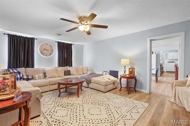 401 S Main St, New Florence, MO 63363 - living area with ceiling fan, light wood finished floors, and washer / dryer