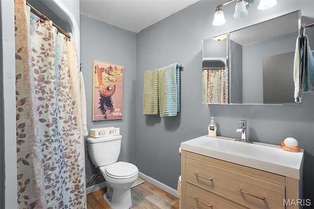 401 S Main St, New Florence, MO 63363 - full bathroom with toilet, vanity, wood finished floors, baseboards, and a shower with curtain