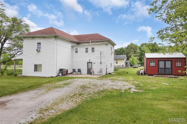 401 S Main St, New Florence, MO 63363 - rear view of house with a patio area, a lawn, and an outdoor structure